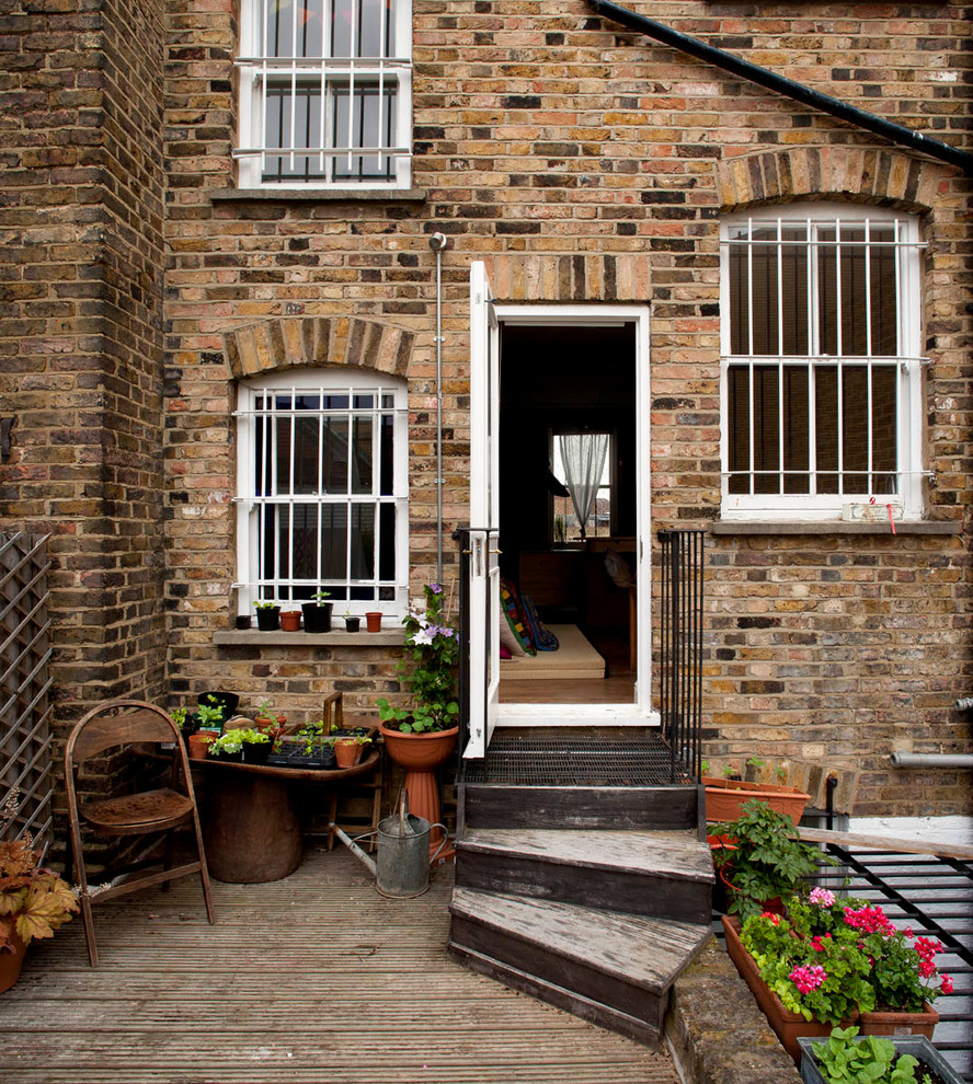 Inspiration for a brown rustic brick house exterior in London.