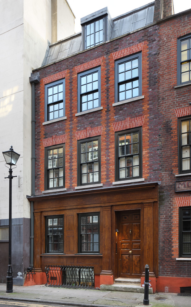 Classic brick house exterior in London with three floors.