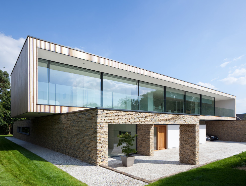 Inspiration for a contemporary two floor house exterior in Hampshire with wood cladding.