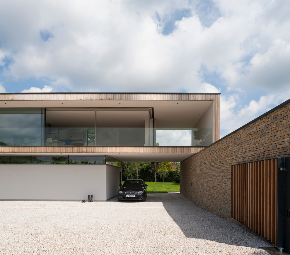 Inspiration for a contemporary two floor house exterior in Hampshire with wood cladding.