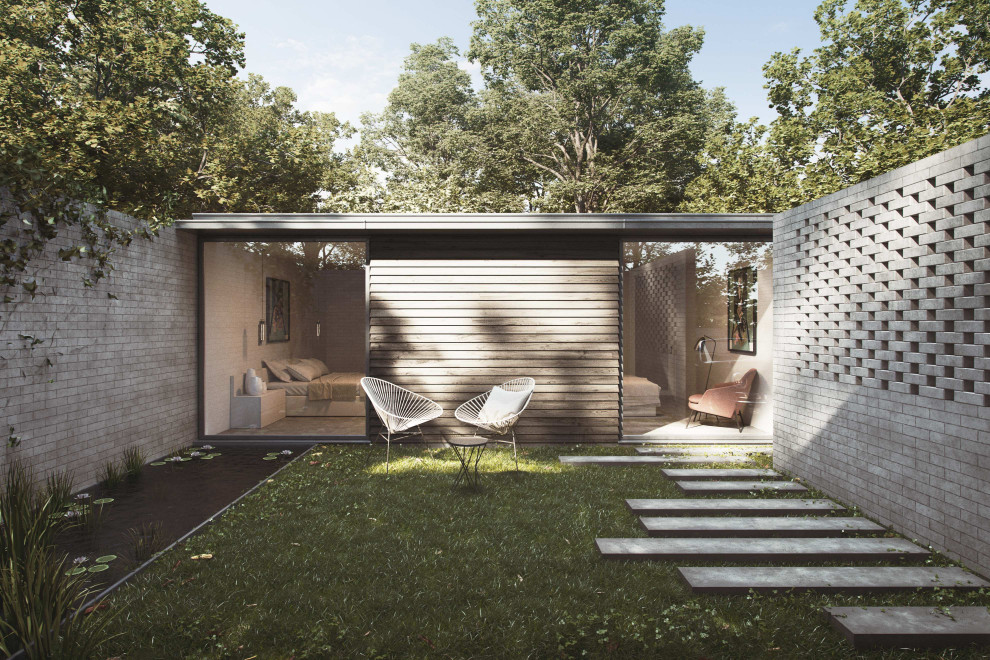 Idées déco pour une petite façade de maison mitoyenne grise contemporaine en brique de plain-pied avec un toit plat et un toit végétal.