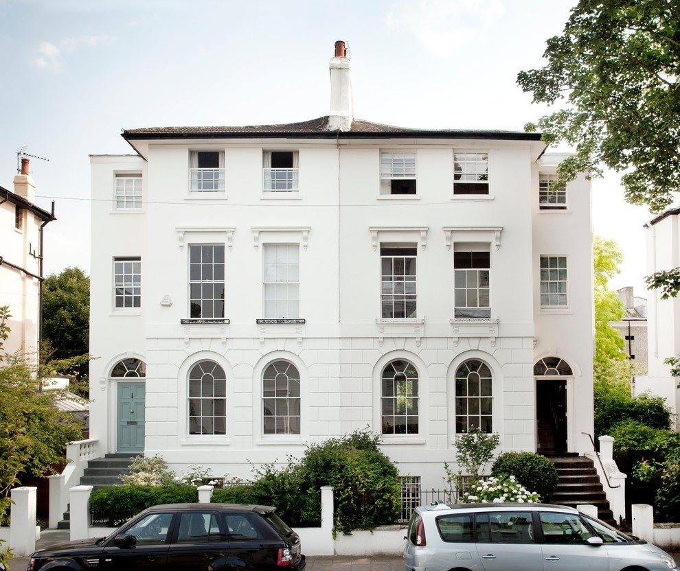 Foto della facciata di una casa bifamiliare bianca classica a tre piani