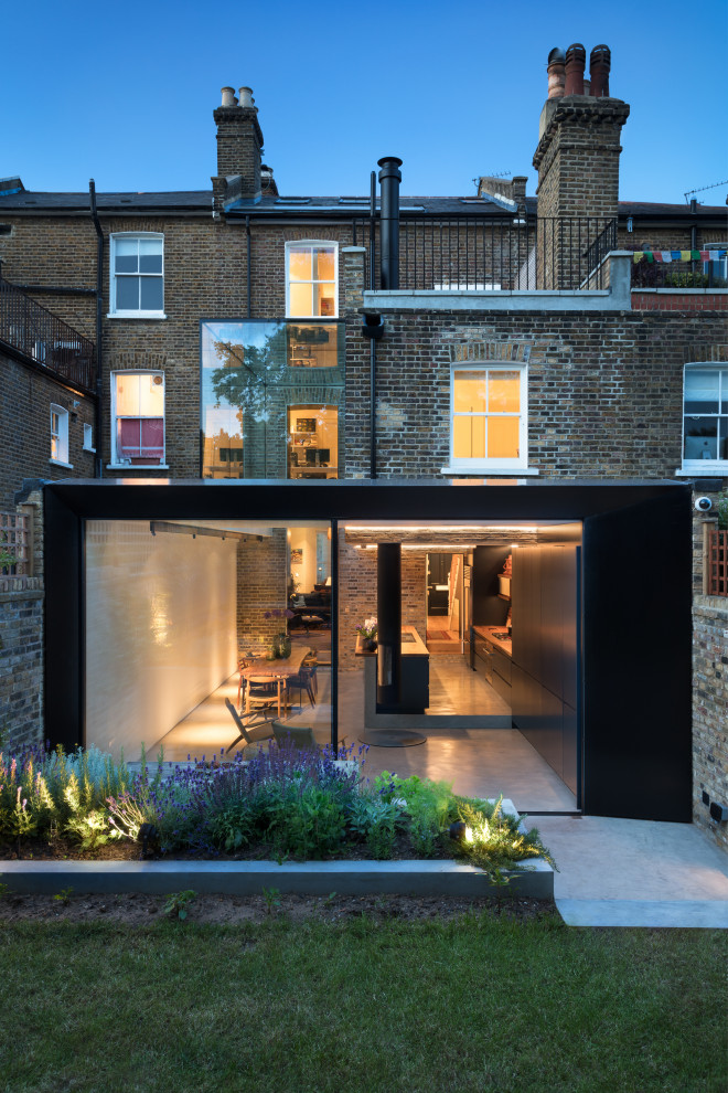 Example of a large trendy black four-story metal exterior home design in London