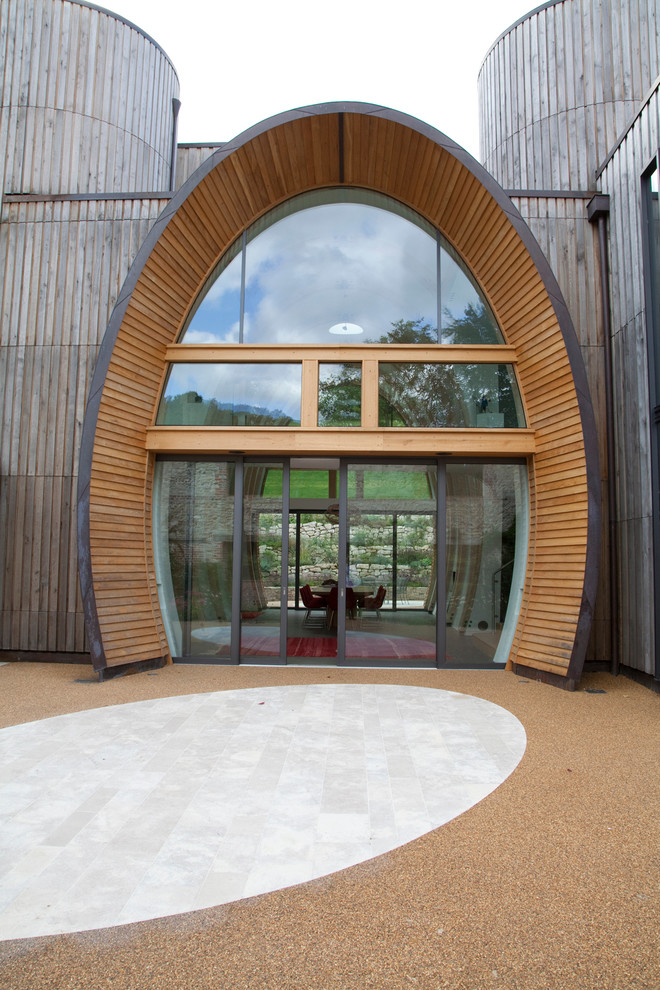 Große Moderne Holzfassade Haus mit brauner Fassadenfarbe und Flachdach in Hertfordshire