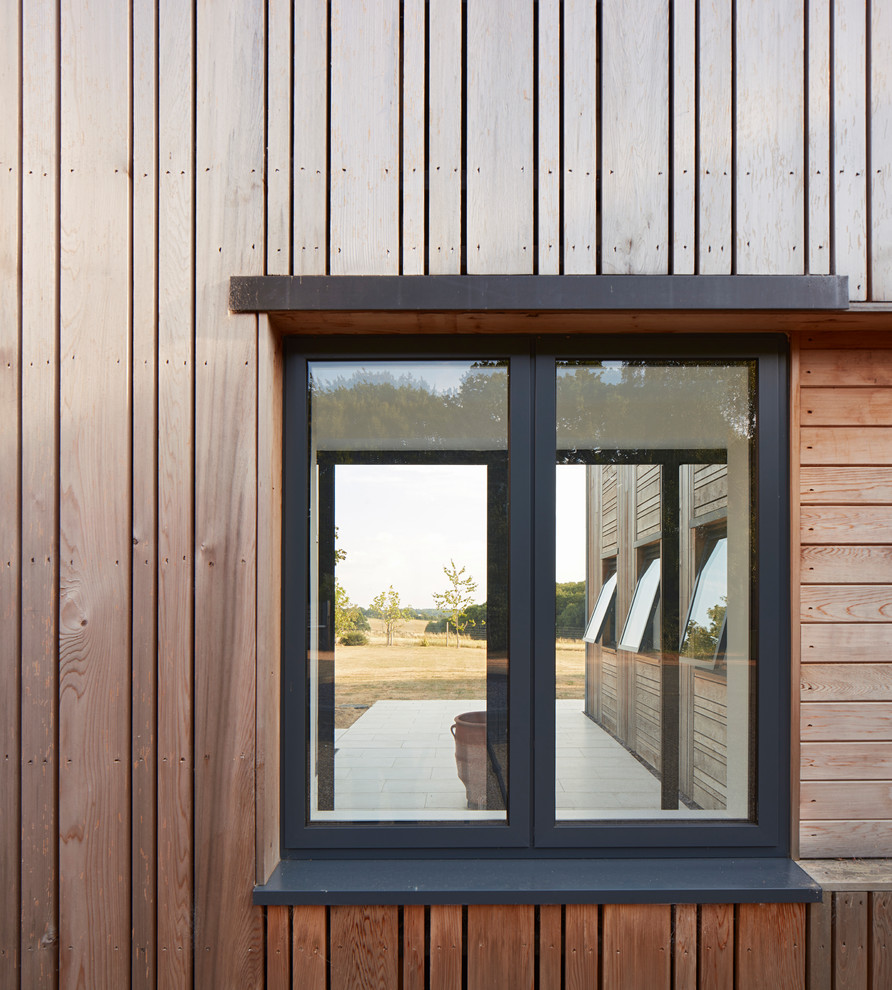 Brown contemporary two floor house exterior in Hertfordshire with wood cladding.