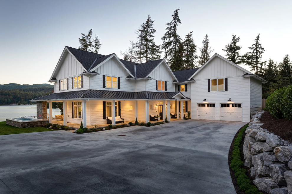Large elegant white two-story wood exterior home photo in Seattle with a mixed material roof
