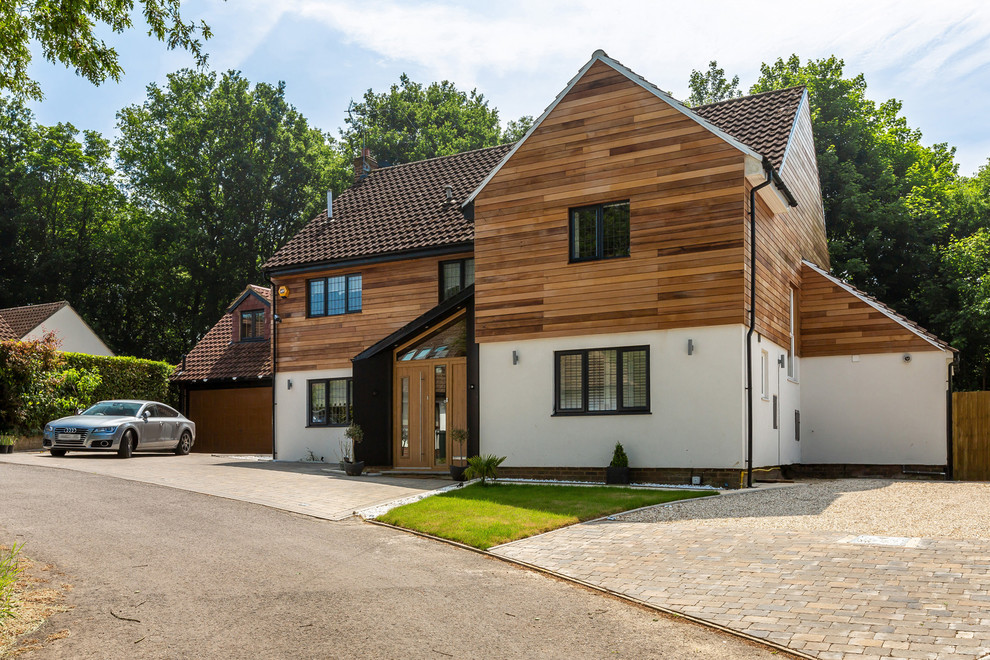 Inspiration for a large transitional brown three-story mixed siding exterior home remodel in Essex with a tile roof