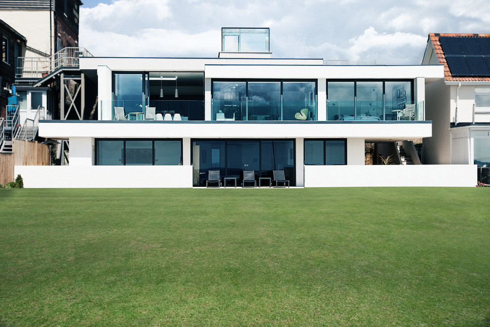 Design ideas for a white modern two floor house exterior in Hampshire.
