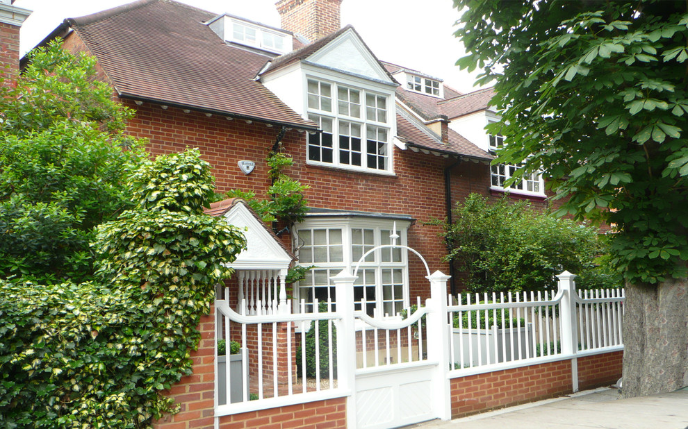 Large two floor brick house exterior in London with a pitched roof.