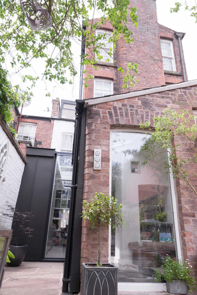 Example of a danish metal exterior home design in Manchester