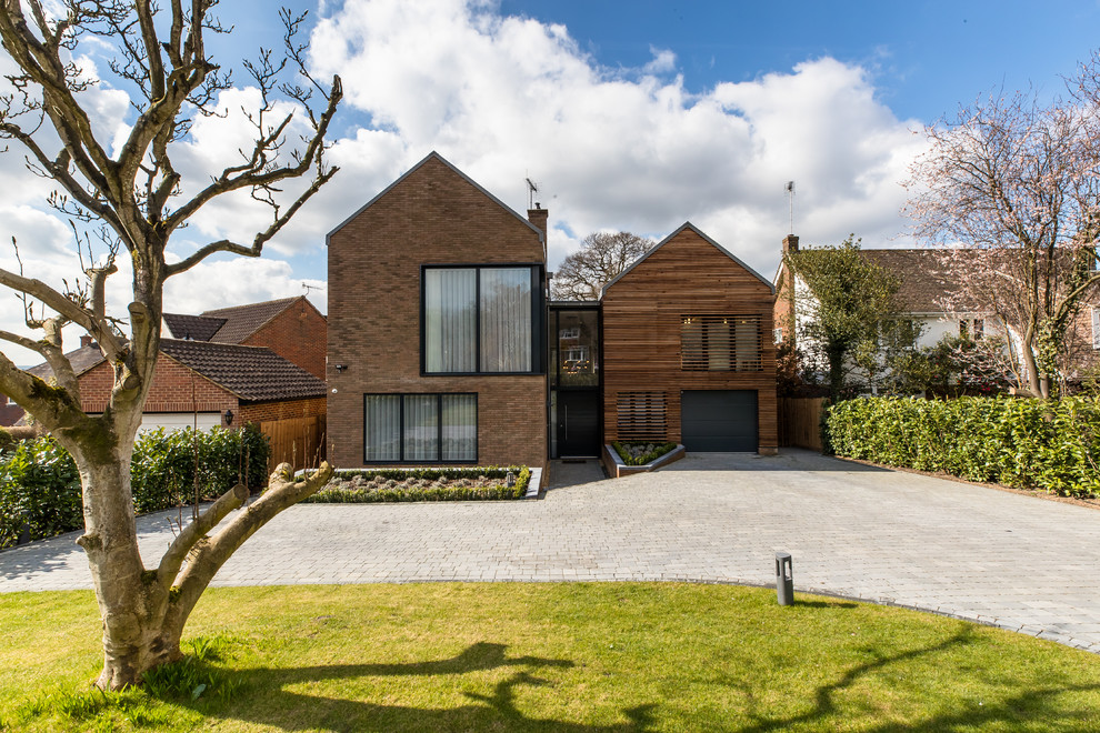 Inspiration for a large contemporary two floor detached house in Surrey with mixed cladding and a pitched roof.