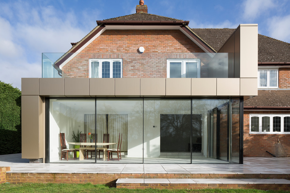 This is an example of a medium sized contemporary house exterior in Surrey.