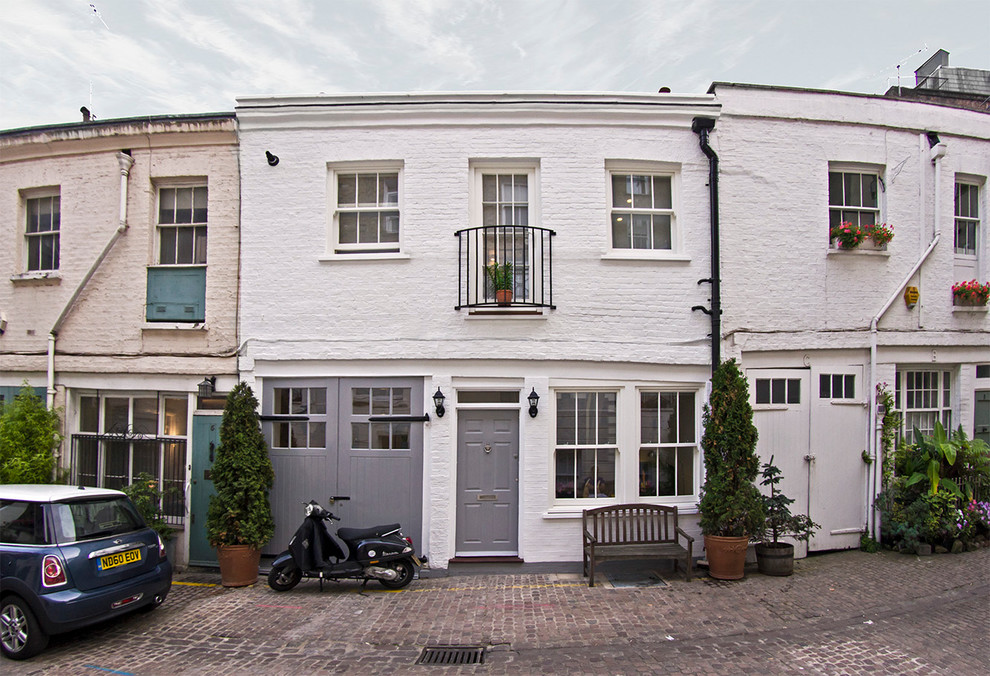 Photo of a small and white traditional two floor brick house exterior in London.