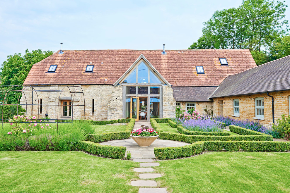 Inspiration for a country two floor house exterior in Gloucestershire with stone cladding.