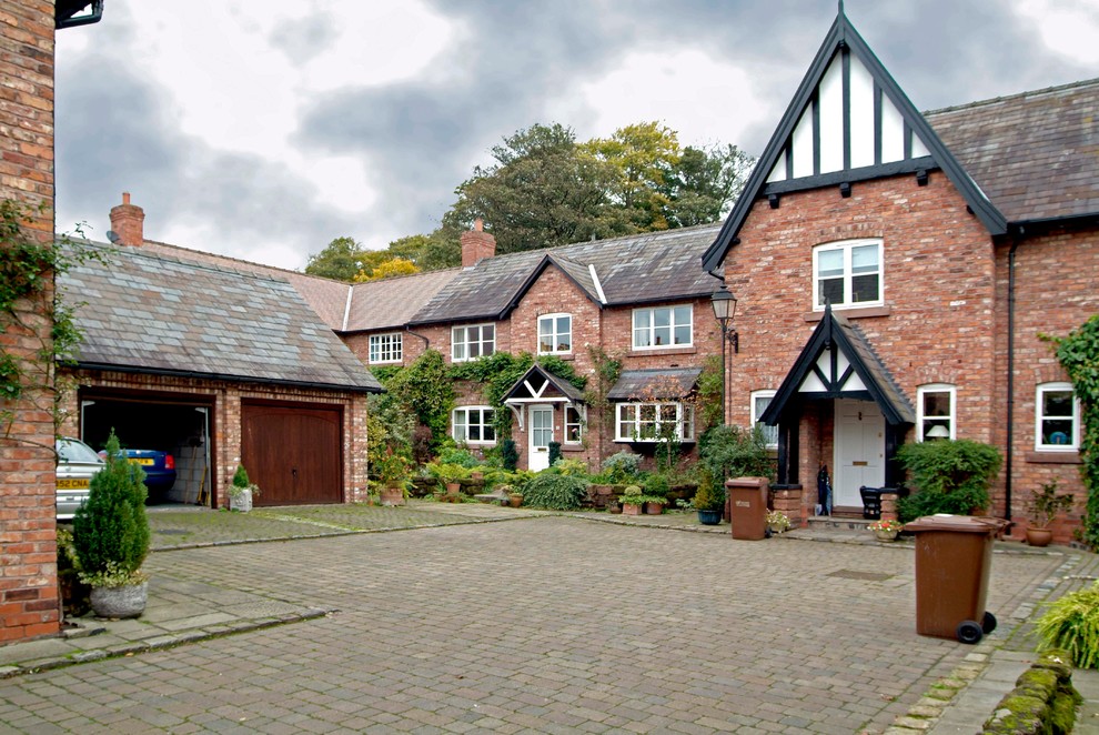 Inspiration for a red classic two floor brick house exterior in Cheshire with a pitched roof.