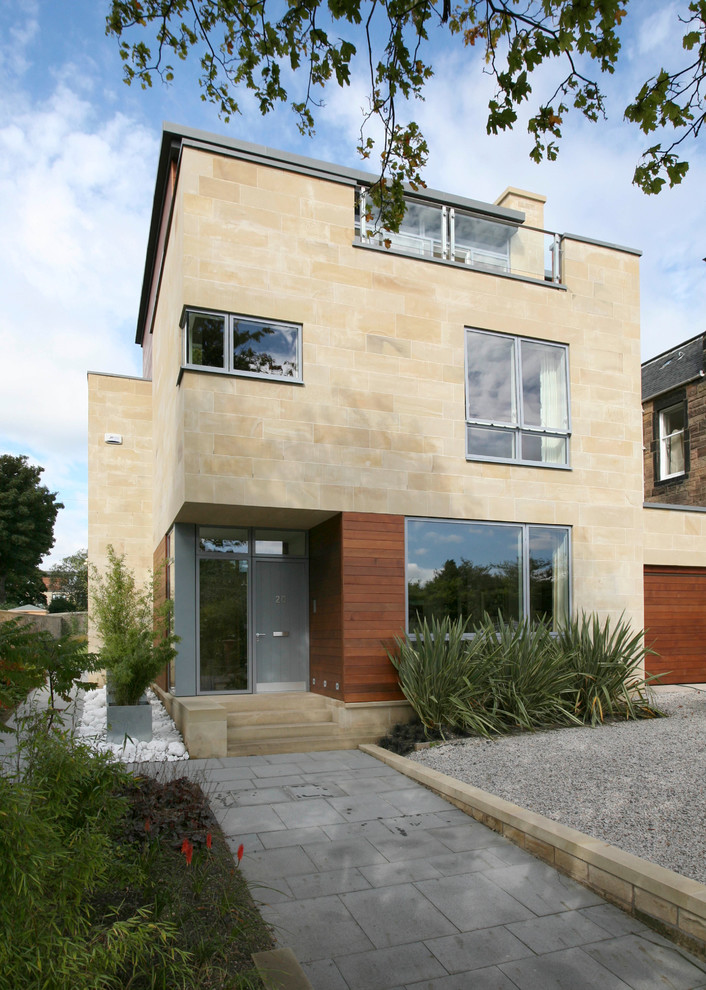 Example of a mid-sized trendy beige three-story stone exterior home design in Edinburgh