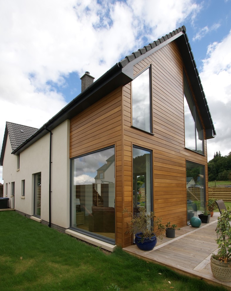 This is an example of a large and white contemporary two floor house exterior in Other with mixed cladding.