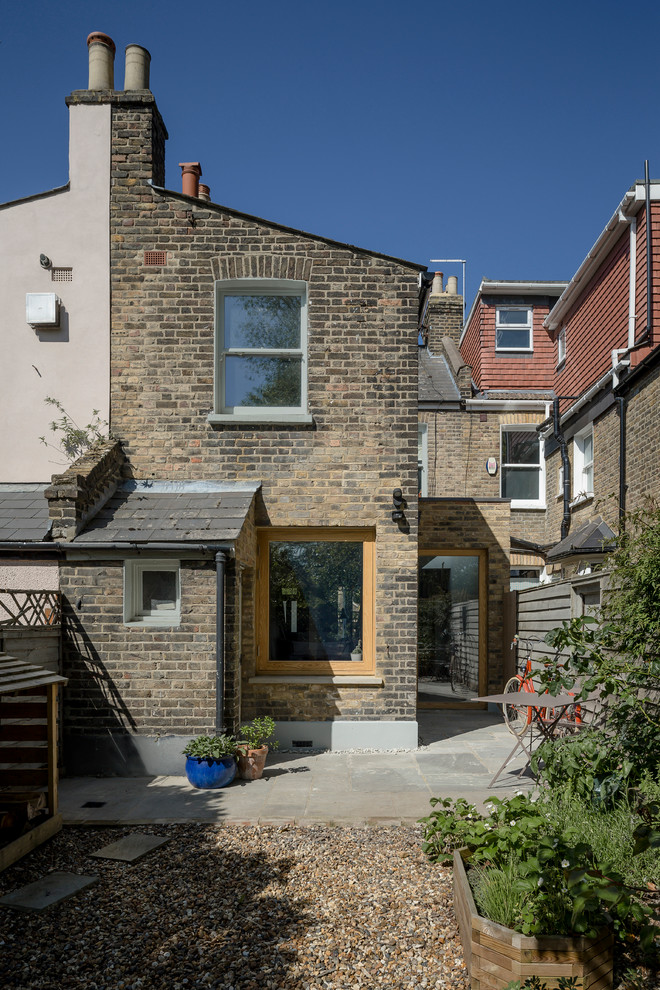 Medium sized contemporary two floor brick house exterior in London with a pitched roof.