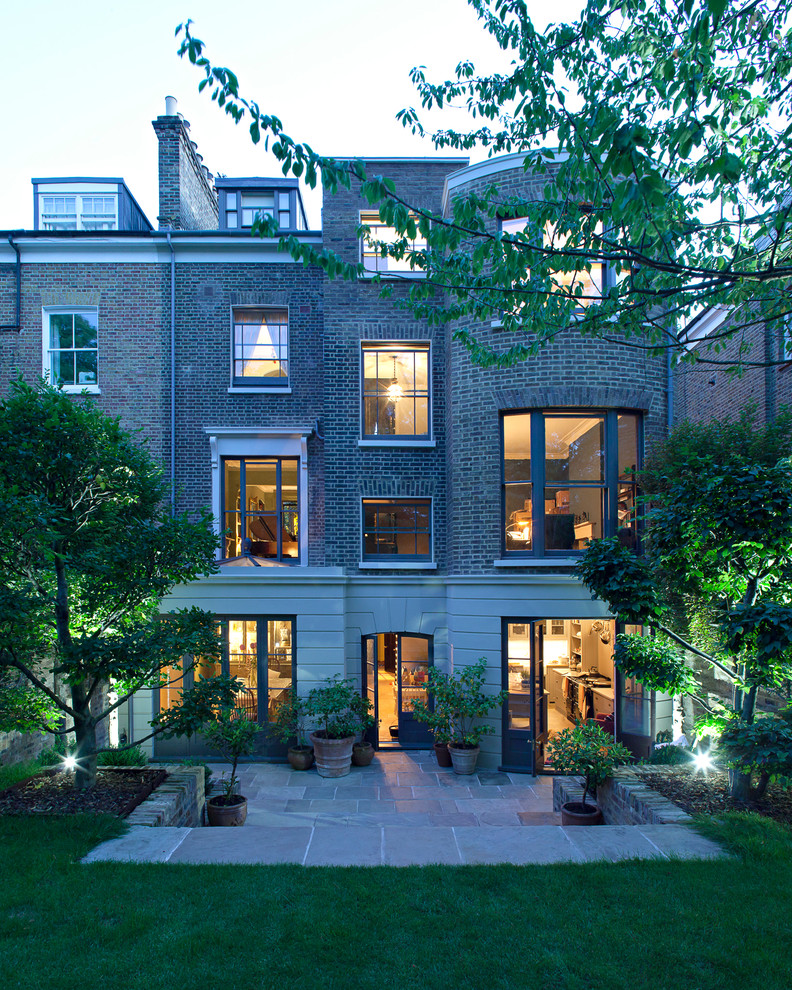 This is an example of a large traditional brick house exterior in London with three floors.