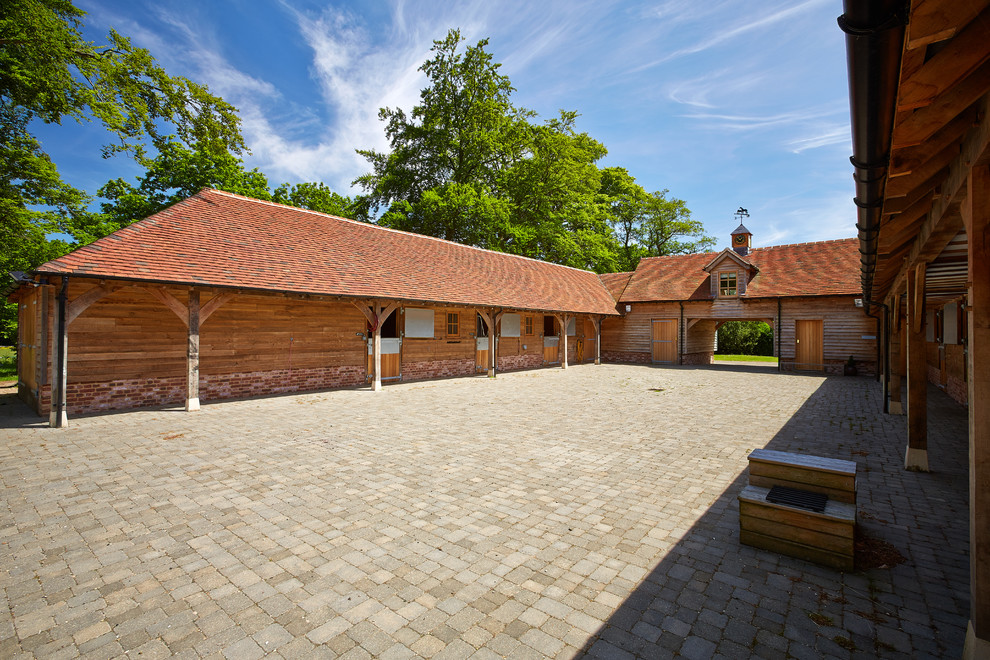 Photo of an expansive classic house exterior in Berkshire with wood cladding.