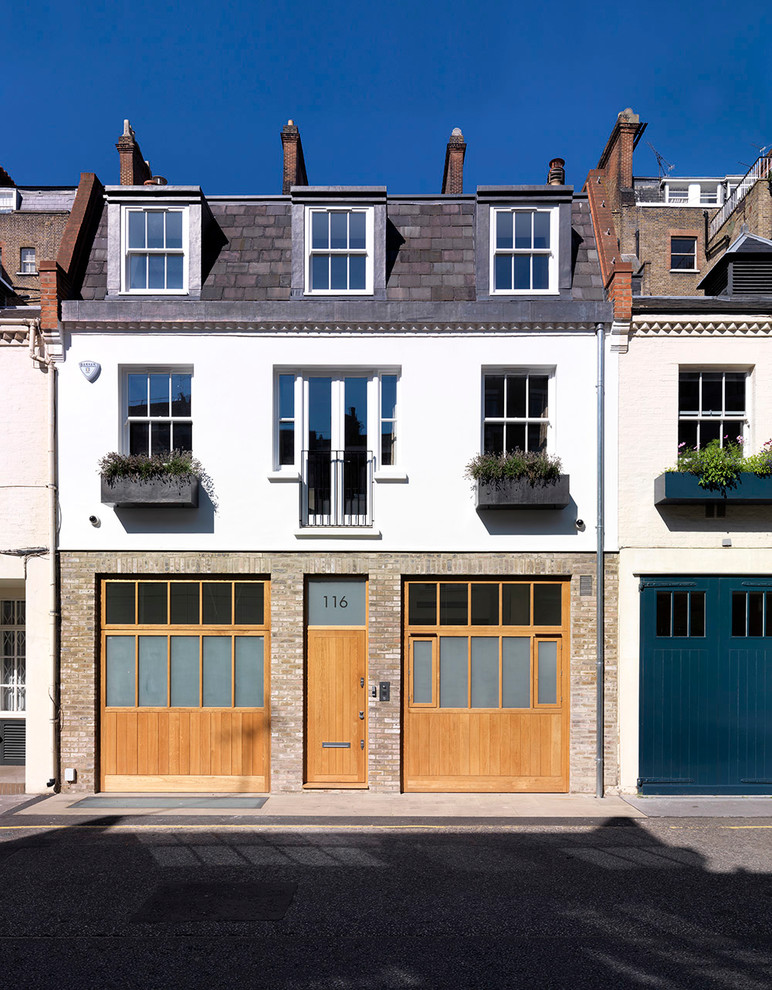 Photo of a contemporary house exterior in London with three floors and mixed cladding.