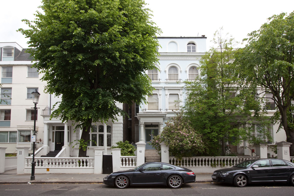 Large and blue traditional house exterior in London with three floors.
