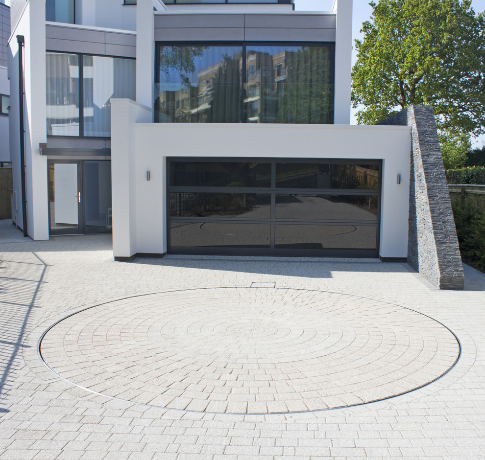 Design ideas for a medium sized and white contemporary house exterior in Dorset with three floors and stone cladding.