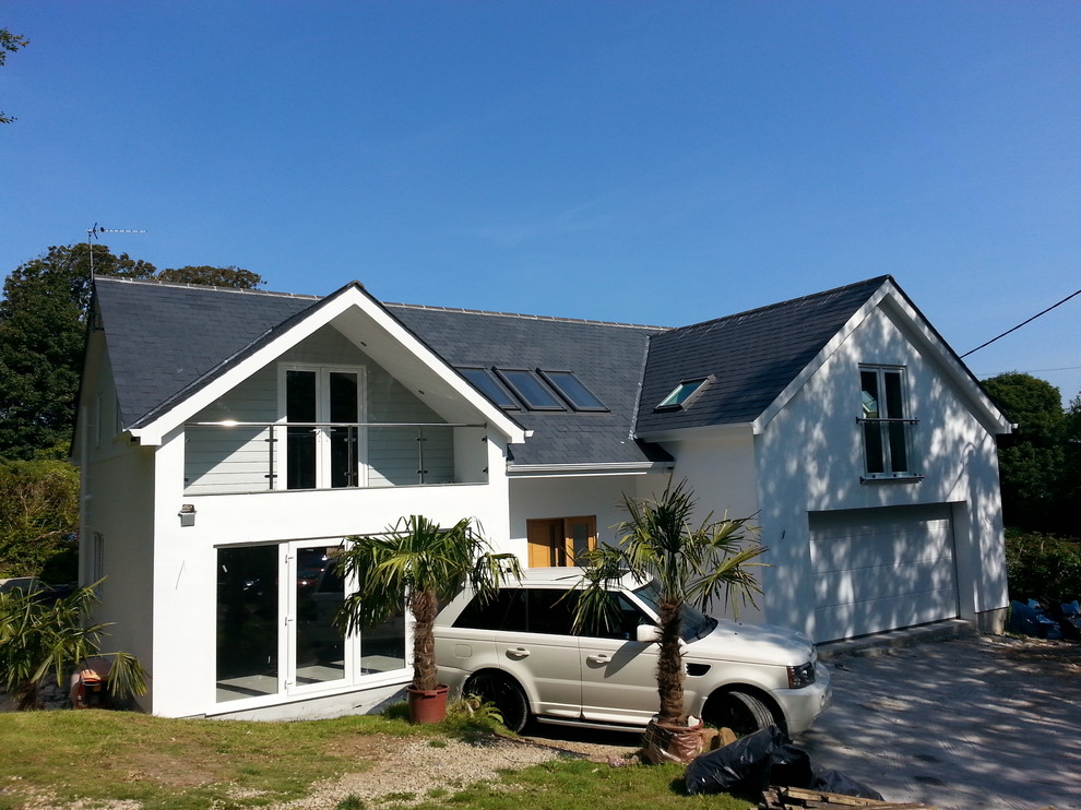 This is an example of a medium sized and white contemporary two floor render house exterior in Cornwall.