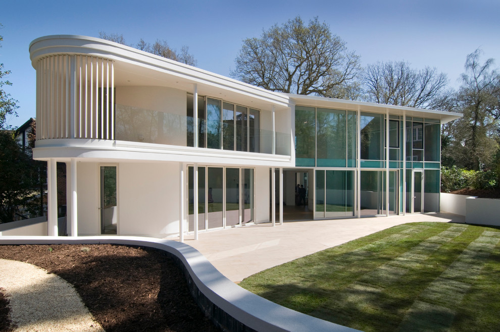 Minimalist white two-story glass exterior home photo in London