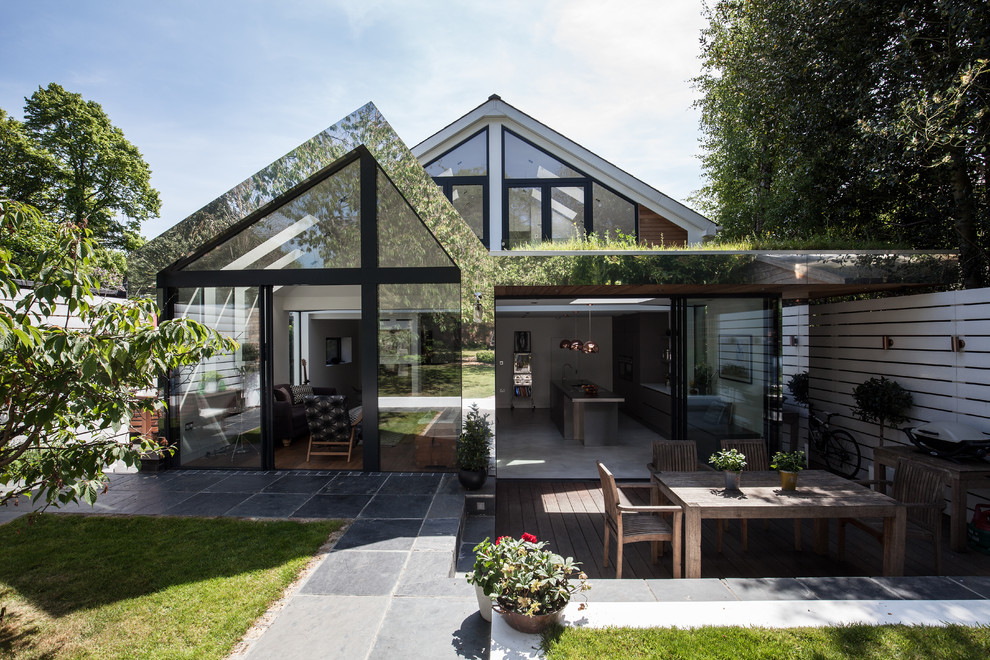 Medium sized and white contemporary two floor detached house in London with metal cladding.