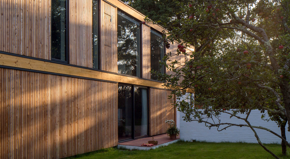 Inspiration for a contemporary two-story wood exterior home remodel in Hampshire