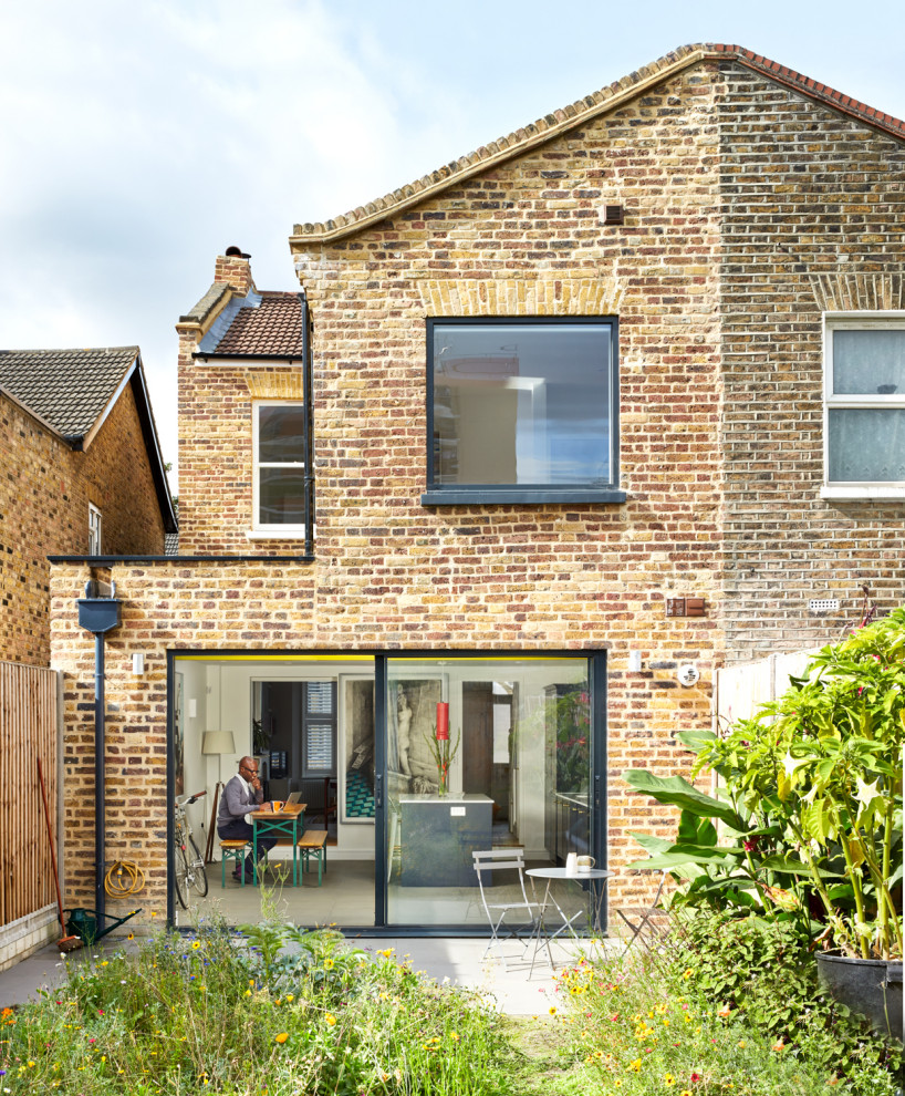 This is an example of a medium sized and brown classic two floor brick terraced house in London with a pitched roof and a tiled roof.