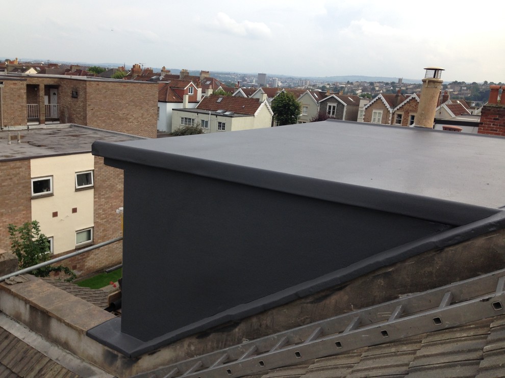 Ejemplo de fachada gris minimalista de tamaño medio de tres plantas con tejado plano