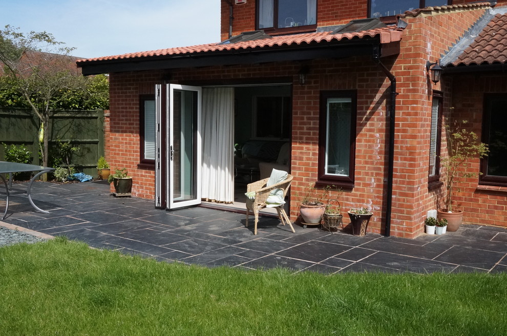 This is an example of a small and brown traditional bungalow brick house exterior in Buckinghamshire.