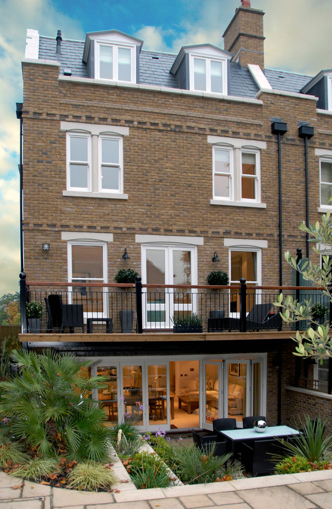 Traditional brick house exterior in London with three floors and a pitched roof.