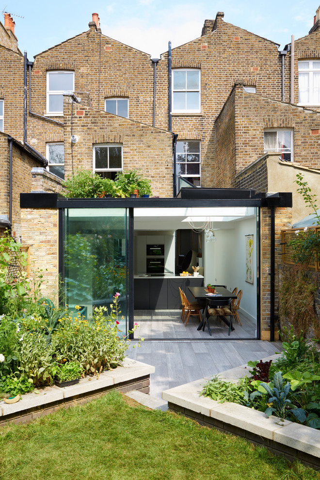 This is an example of a contemporary bungalow glass and rear extension in London.