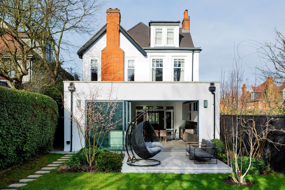 Inspiration for a large and white contemporary render detached house in London with a hip roof.