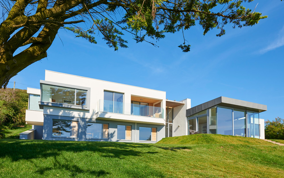 Large and white contemporary two floor house exterior in Devon with a flat roof.