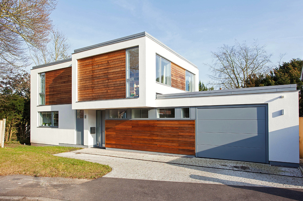 Design ideas for a contemporary house exterior in Hampshire with wood cladding.
