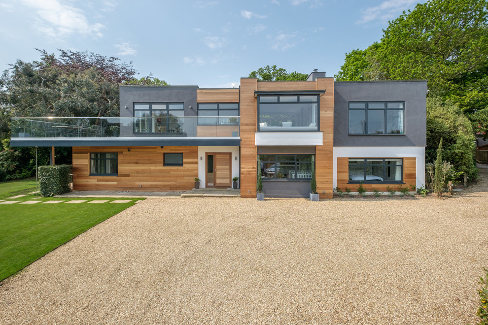 This is an example of a large contemporary two floor detached house in Other with mixed cladding and a flat roof.