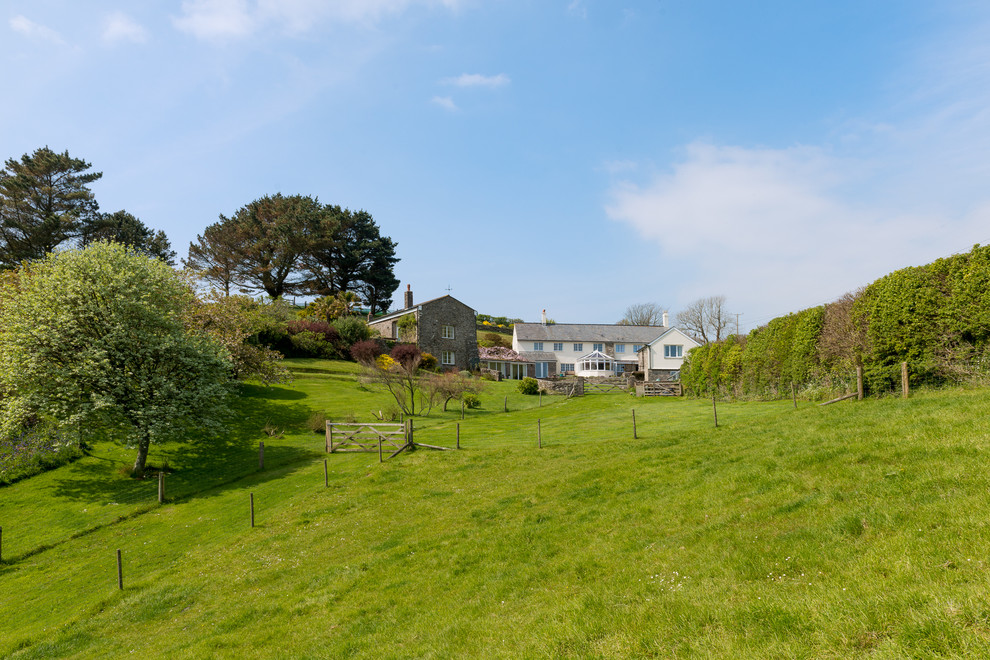This is an example of an expansive rural two floor house exterior in Devon.