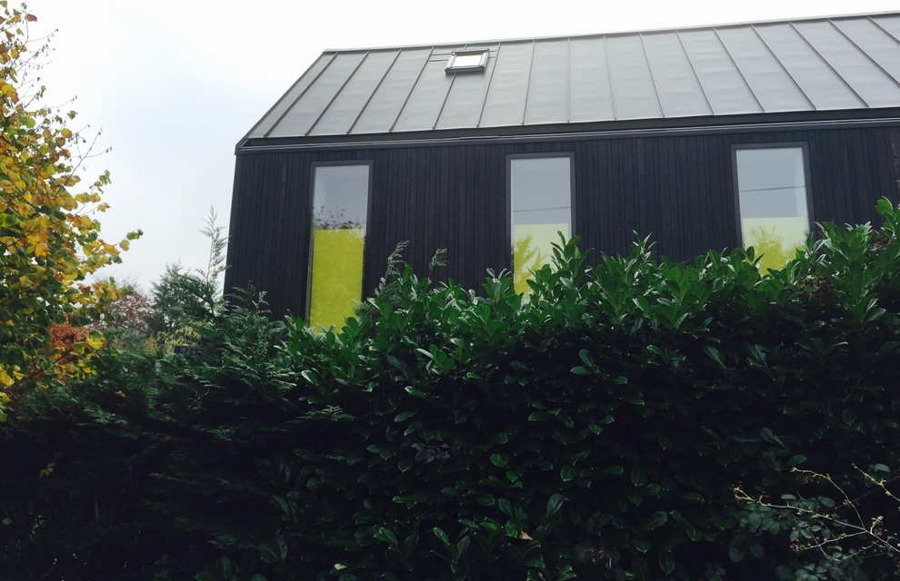 Design ideas for a medium sized and black classic two floor house exterior in Buckinghamshire with wood cladding.