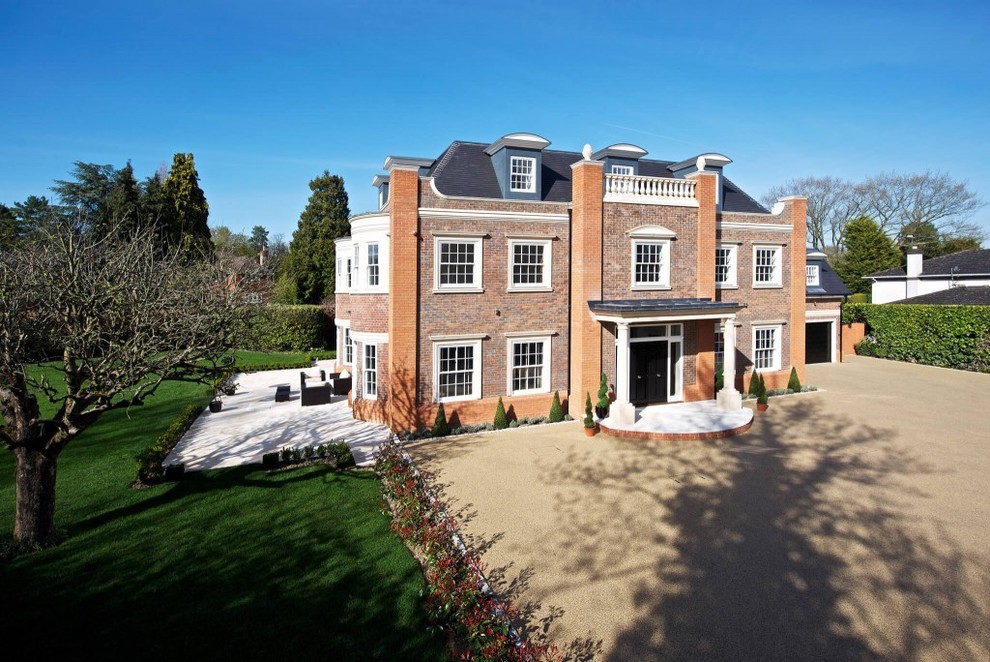 Expansive and brown contemporary brick house exterior in Sussex with three floors.
