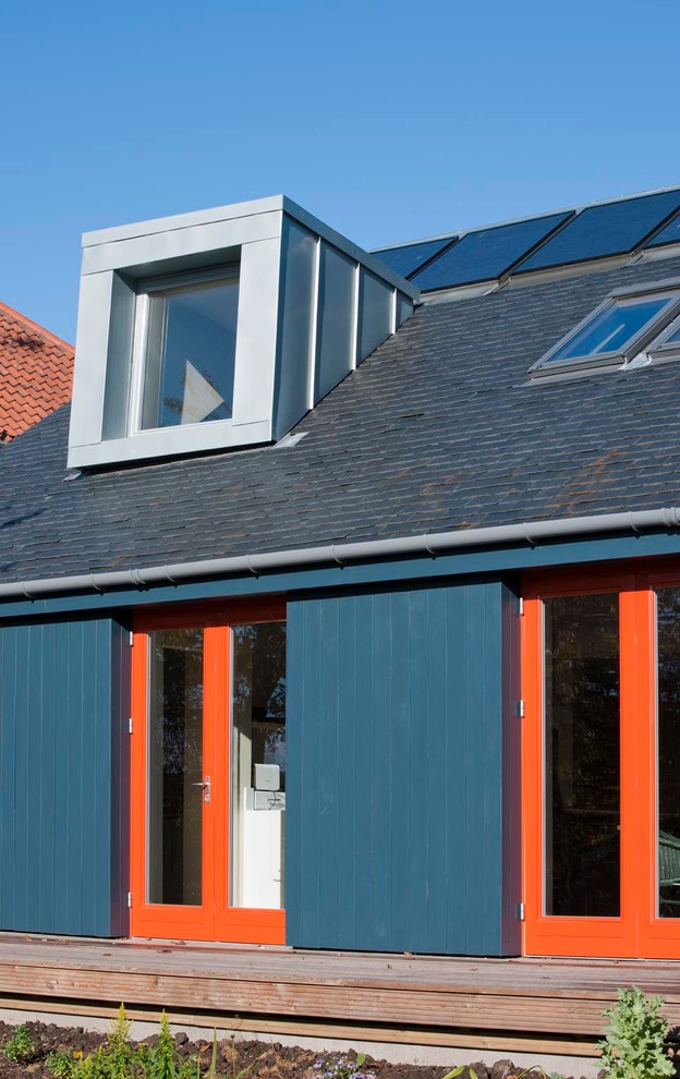 Inspiration for a medium sized and blue contemporary two floor house exterior in Edinburgh with wood cladding.