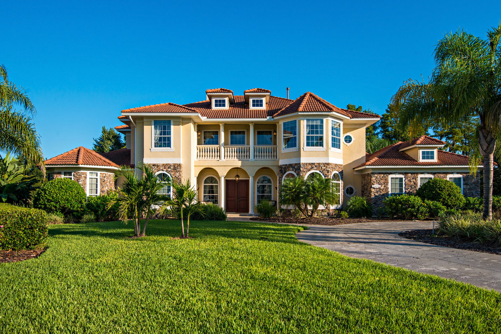 Island style stone exterior home photo in Orlando