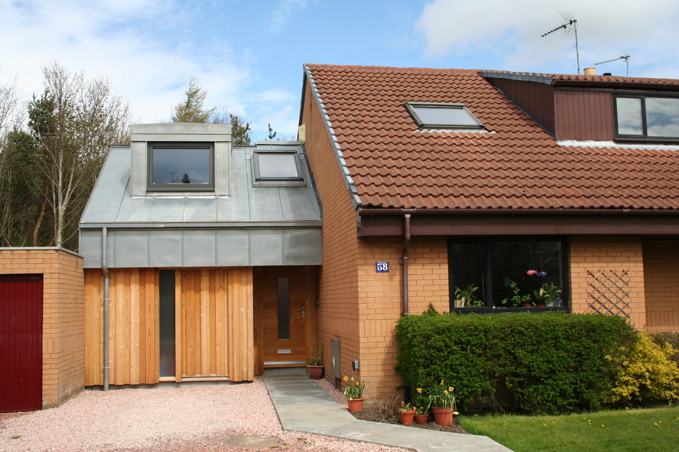 This is an example of a small contemporary two floor semi-detached house in Edinburgh with wood cladding, a pitched roof and a metal roof.