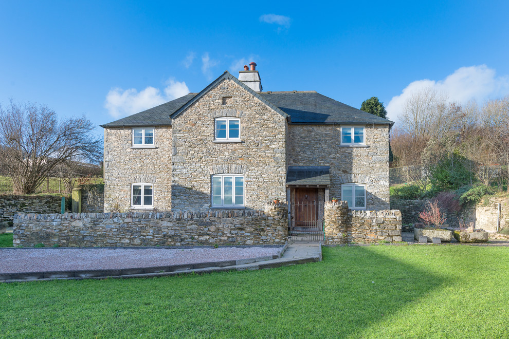 Inspiration for a rural house exterior in Devon with stone cladding.