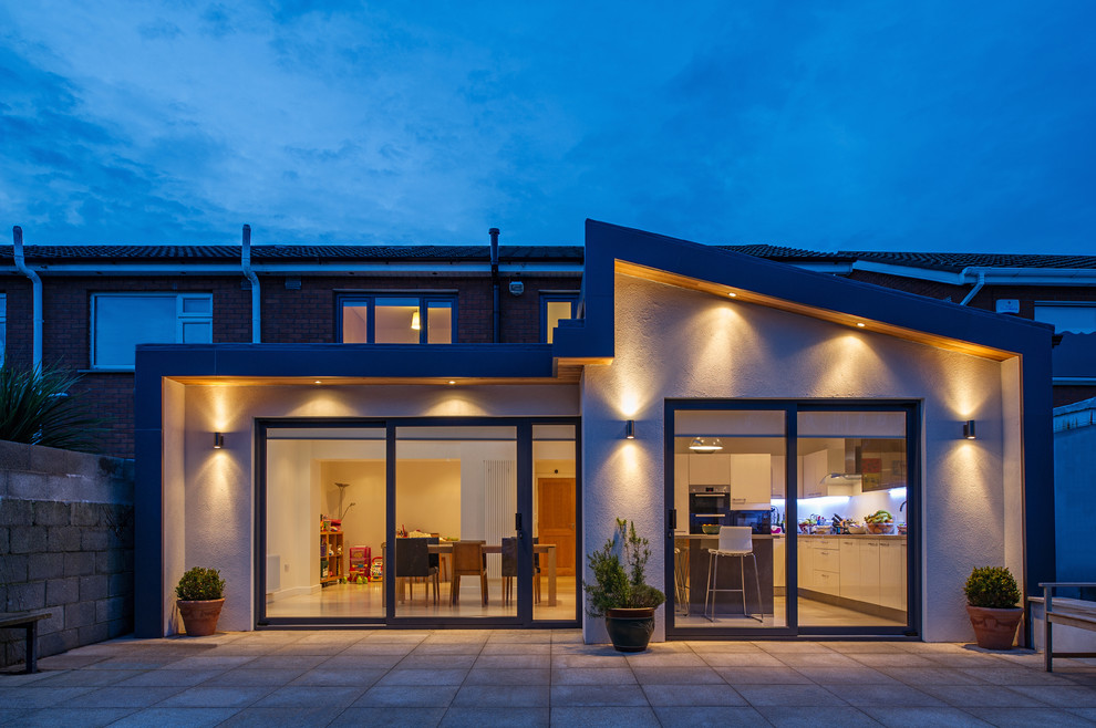 Inspiration for a medium sized contemporary bungalow render house exterior in Dublin.