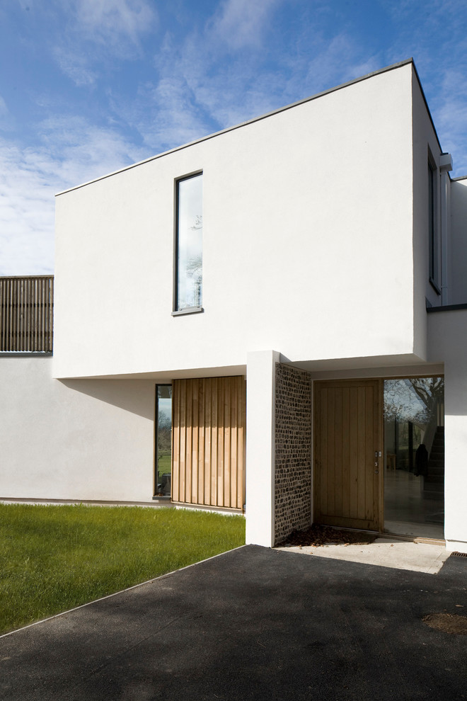 White modern two floor house exterior in London with a flat roof.
