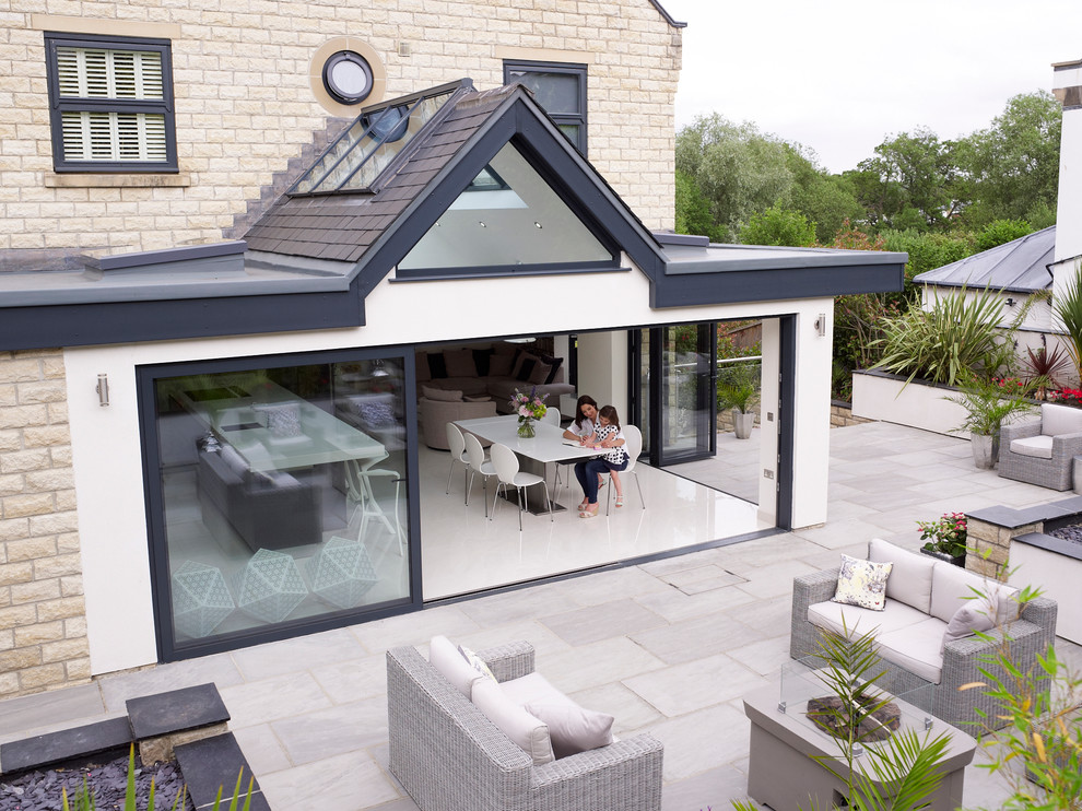 Expansive and white contemporary bungalow render detached house in Kent with a flat roof and a mixed material roof.